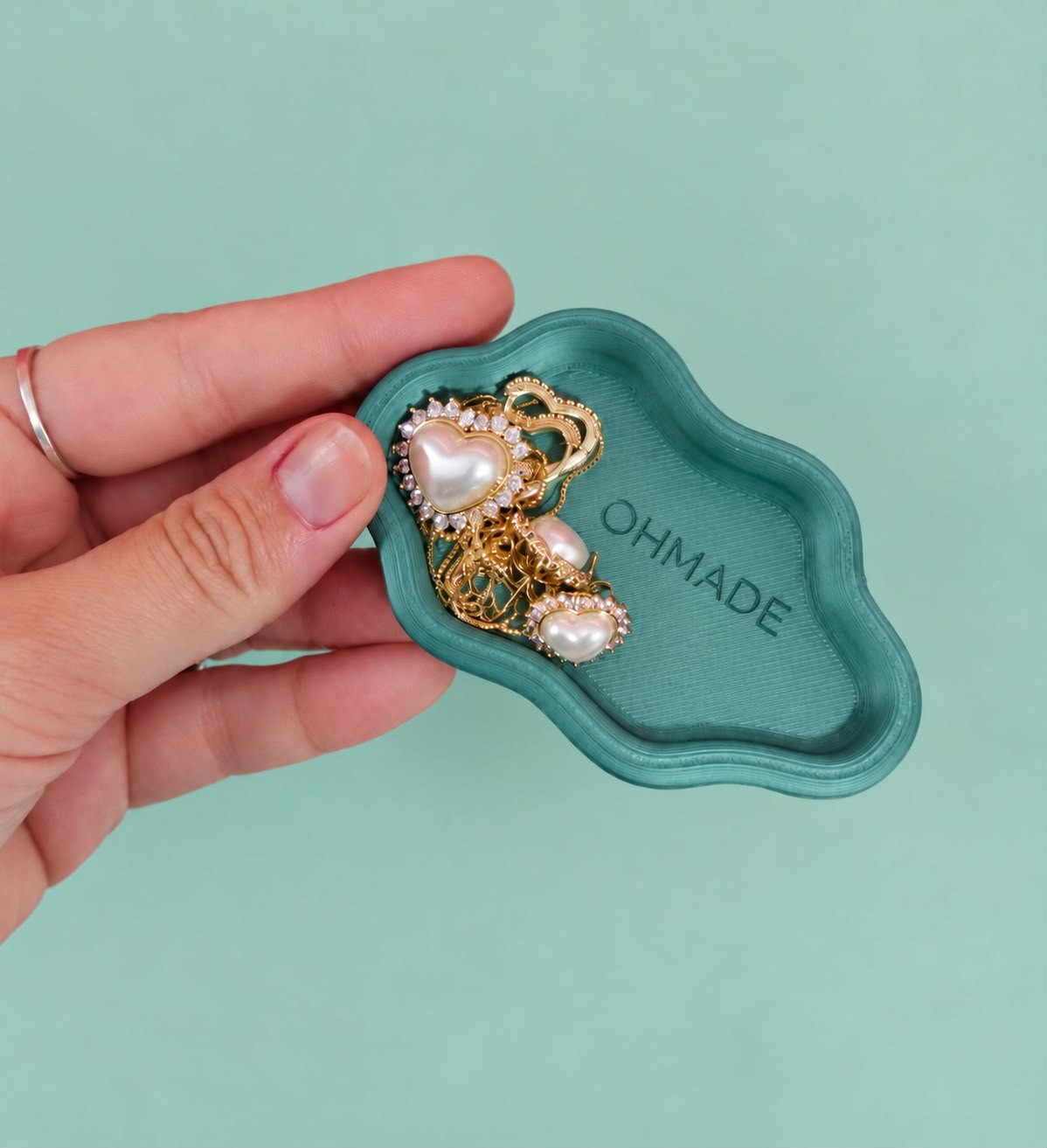 Hand holding a cloud jewellery tray with jewellery