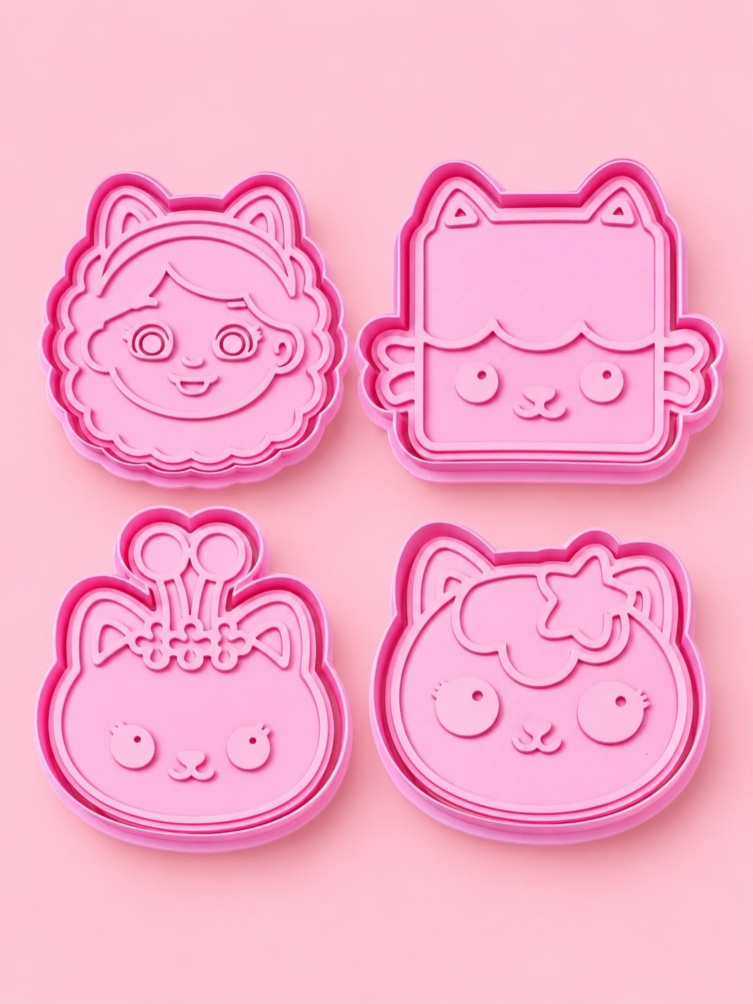 Pink cookie cutters with cute faces