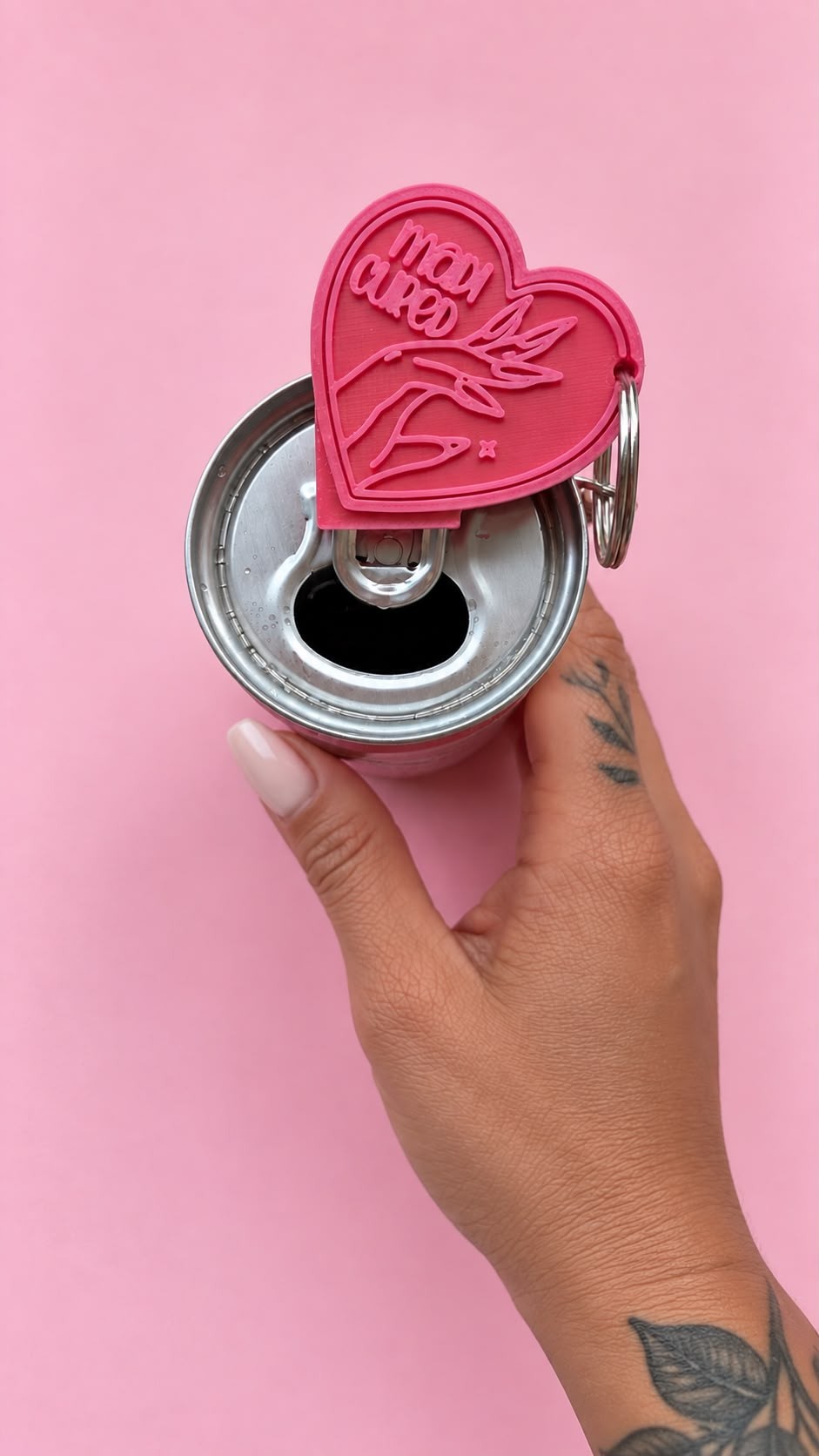 Heart can opener keychain on an open can