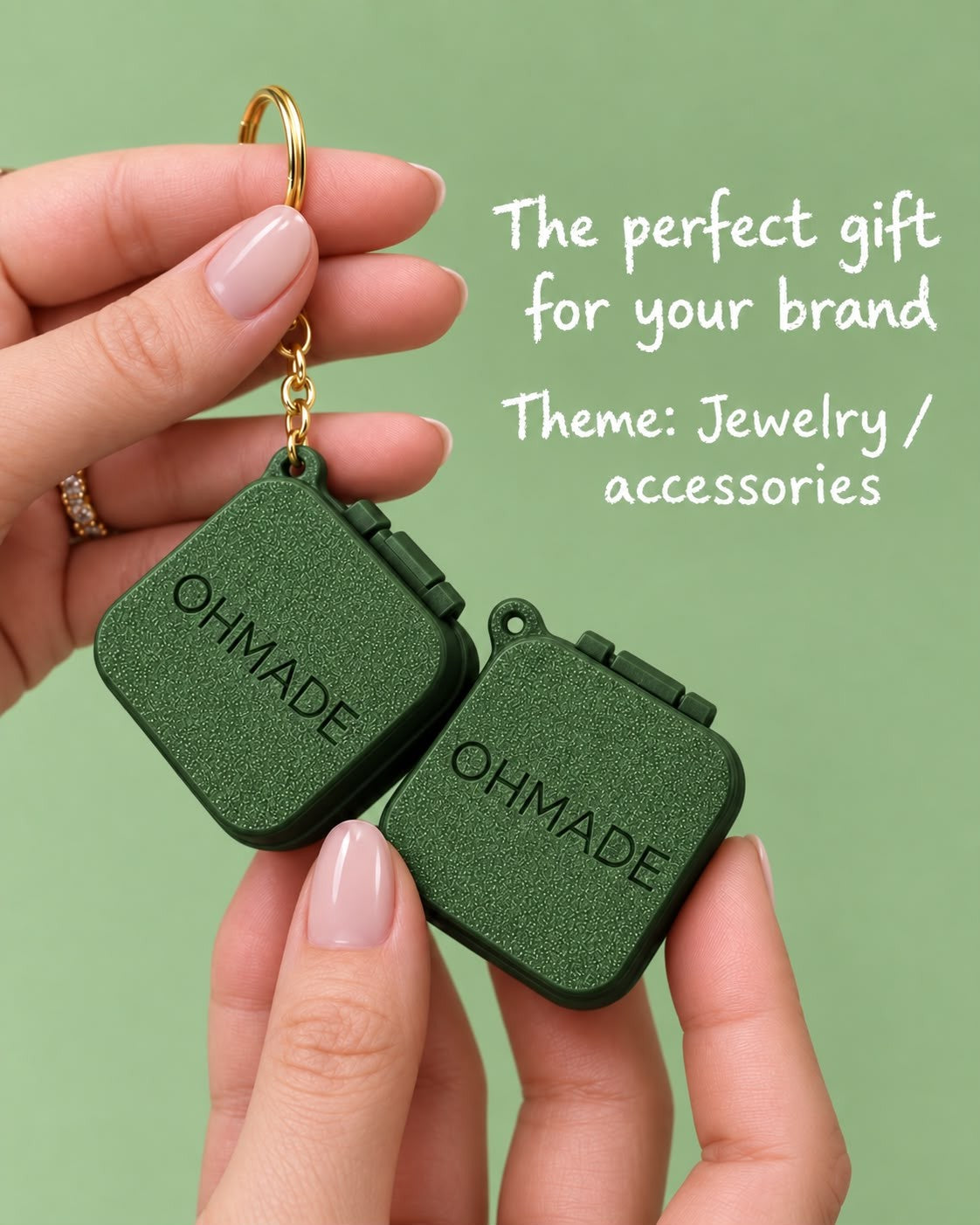 Two jewellery box keychains with a custom logo, held in hand