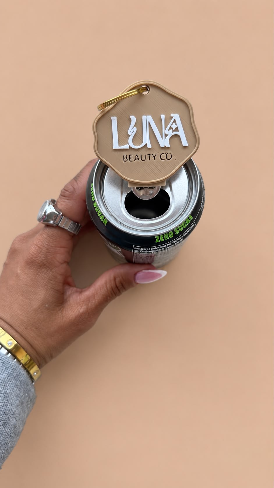Logo tag keychain opening a can