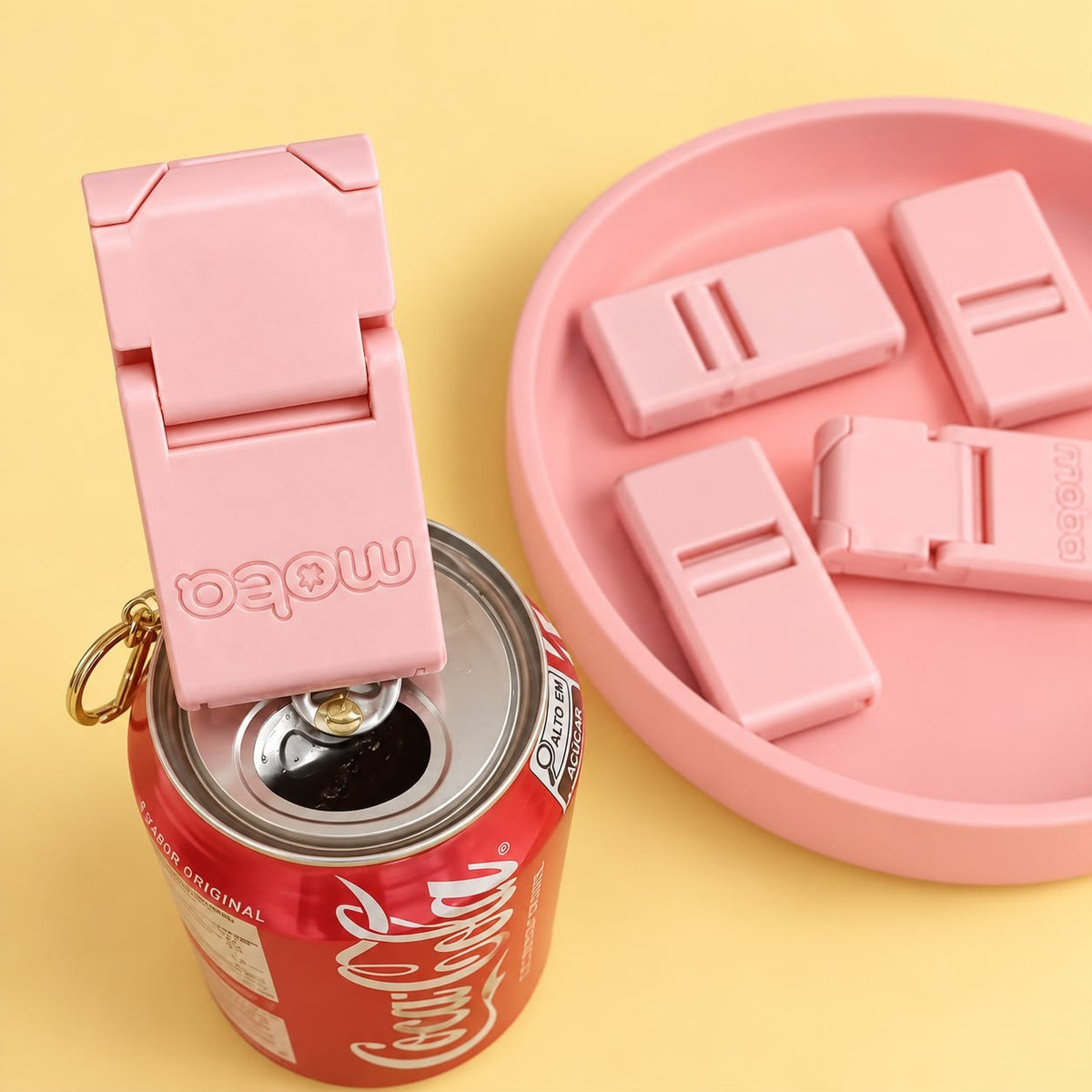 Pink phone stand keychain on an open can