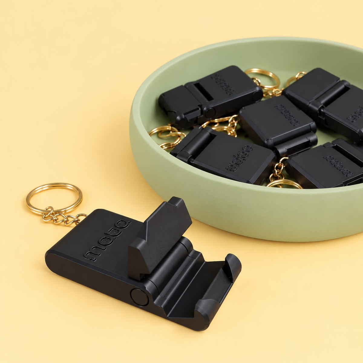 Black phone stand keychains with a custom logo