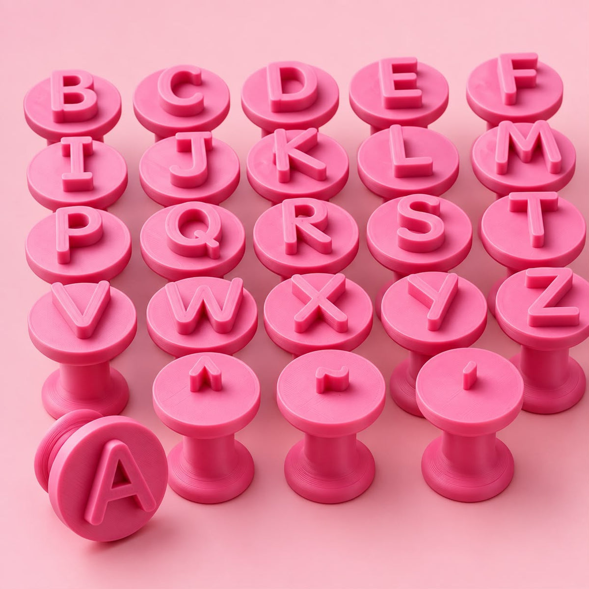 Pink alphabet embossing stamps