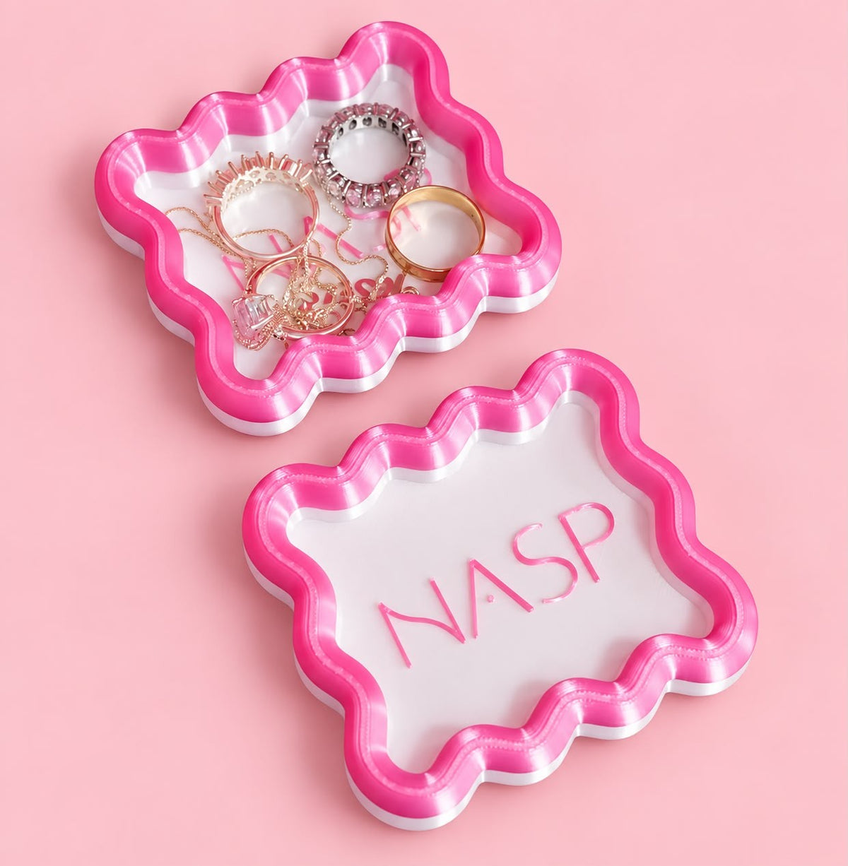 Wavy jewellery trays with a custom logo holding rings